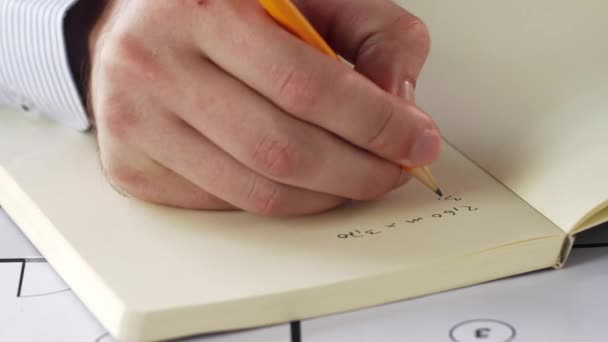 Architect hand with blueprint writing to notebook — Stock Video