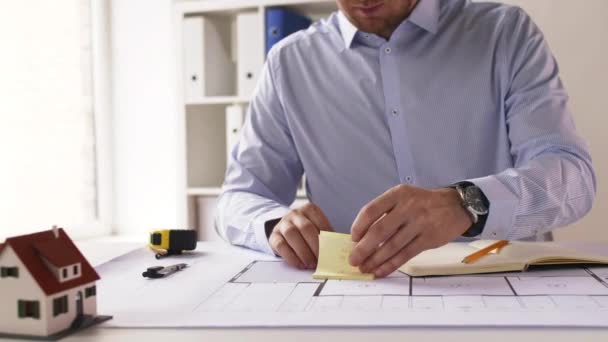 Male architect with ruler measuring blueprint — Stock Video