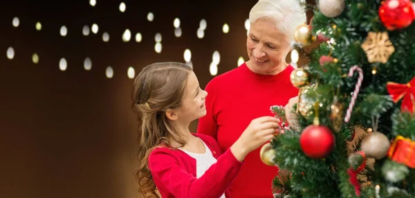 Happy family decorating christmas tree — Stock Photo, Image