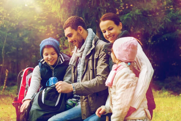 Happy family drinking hot tea at camp — Stock Photo, Image