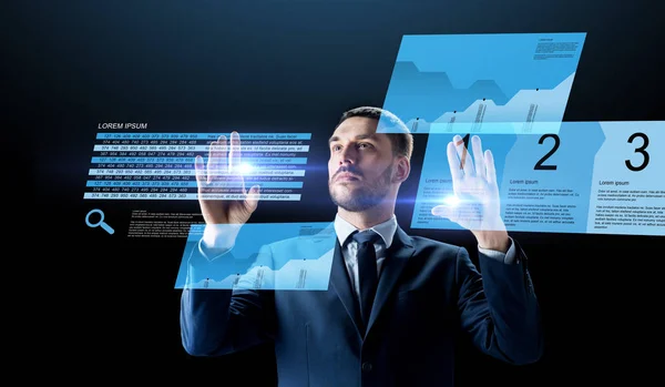 Businessman with stock charts on virtual screens — Stock Photo, Image