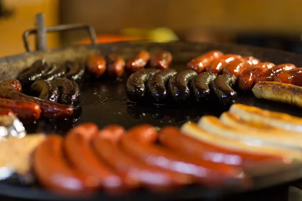 Sausages and salmon frying in stir fry pan — Stock Photo, Image