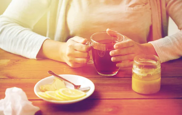 女人将柠檬添加到茶杯的特写 — 图库照片