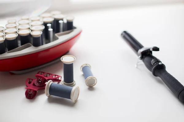 Hot rollers kit on table with hair clips and iron — Stock Photo, Image