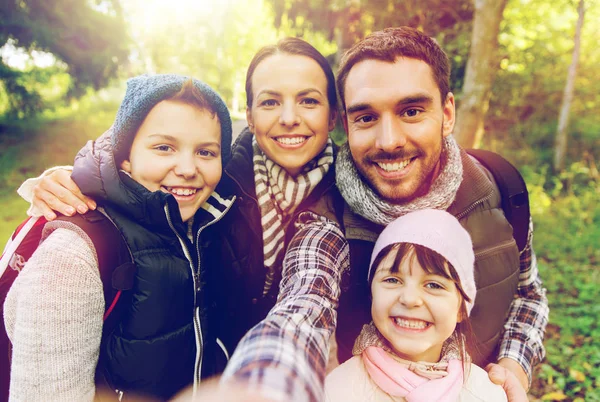 Familia con mochilas tomando selfie y senderismo —  Fotos de Stock