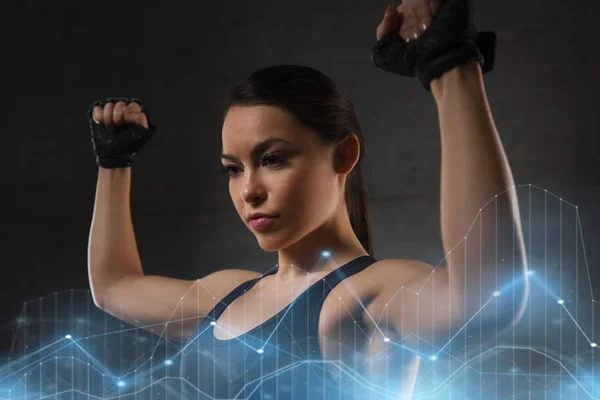 Mujer joven flexionar los músculos en el gimnasio —  Fotos de Stock