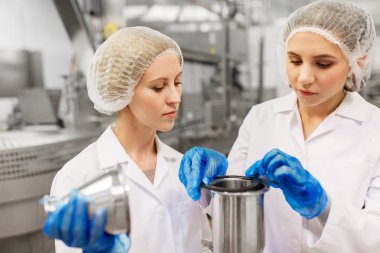 women technologists working at ice cream factory clipart