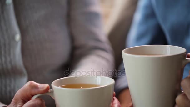 Senior couple hands with cups of tea — Stock Video