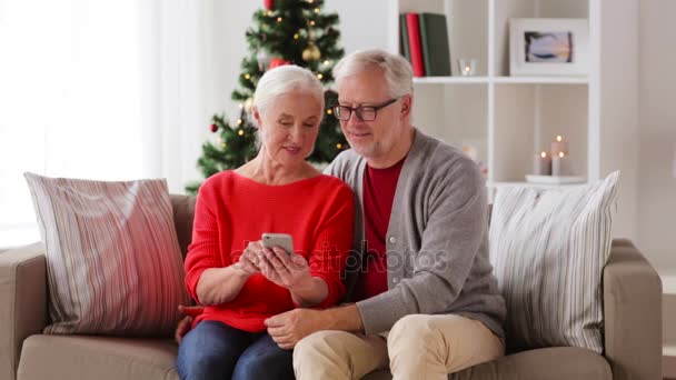 Happy senior couple with smartphones at home — Stock Video