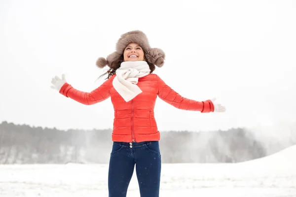 Счастливая женщина в зимней меховой шапке, весело проводящая время на свежем воздухе — стоковое фото