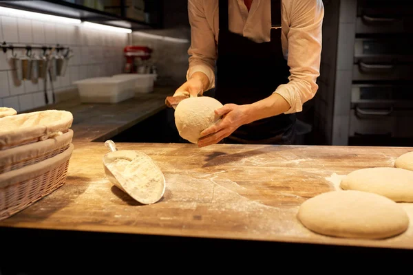 Panettiere porzionatura pasta con banco taglierina in panetteria — Foto Stock