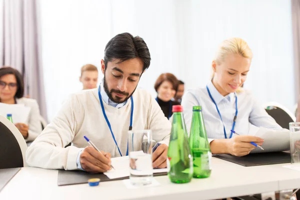 Businesspeople with papers at conference — Stock Photo, Image