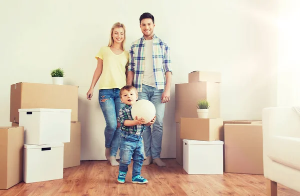 Happy family moving to new home and playing ball — Stock Photo, Image