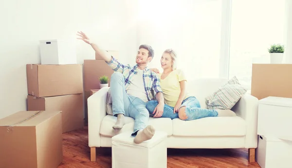 Couple with boxes moving to new home and dreaming — Stock Photo, Image