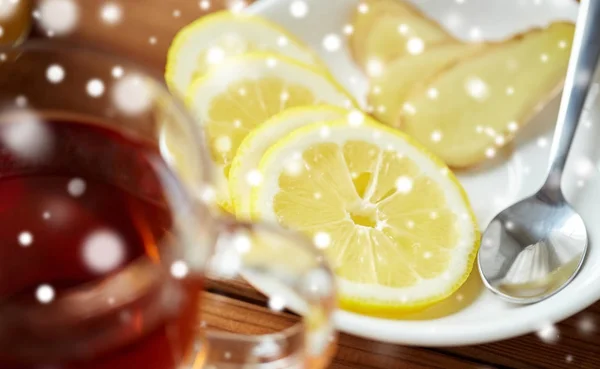 Cangkir teh dengan lemon dan jahe di piring — Stok Foto