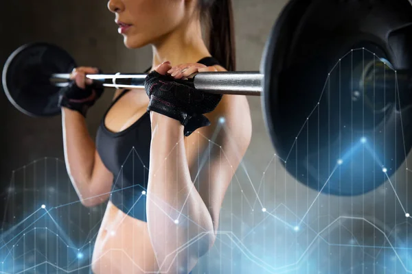 Woman holding barbell in gym — Stock Photo, Image