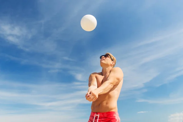 Young man with ball playing volleyball on beach — Stock Photo, Image