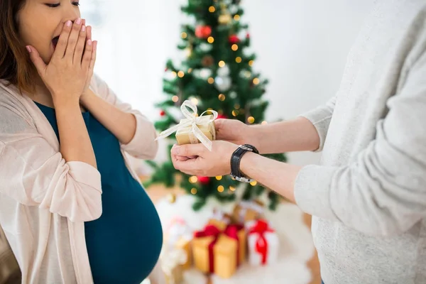 Echtgenoot van geven kerstcadeau aan zwangere vrouw — Stockfoto