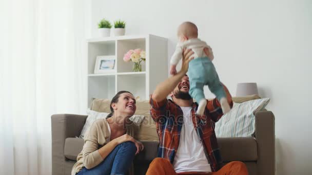 Happy mother and father playing with baby at home — Stock Video