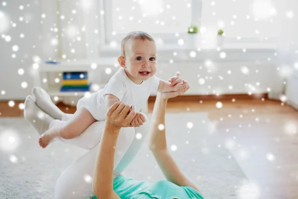 Mãe feliz brincando com o bebê em casa — Fotografia de Stock