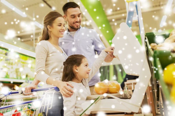 Famille pesant des oranges sur la balance à l'épicerie — Photo