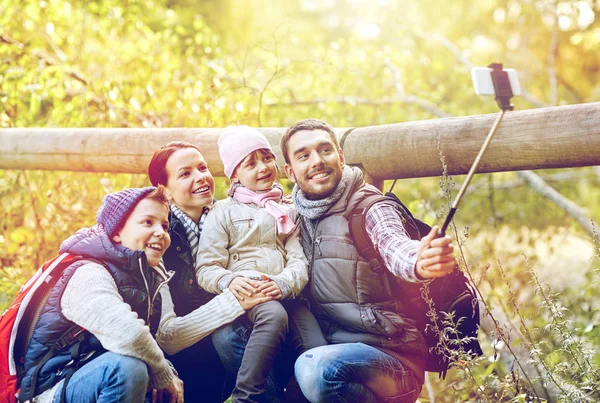 Famiglia felice con smartphone selfie bastone nel bosco — Foto Stock