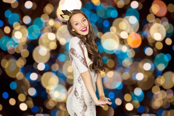 Happy young woman in crown over festive lights — Stock Photo, Image