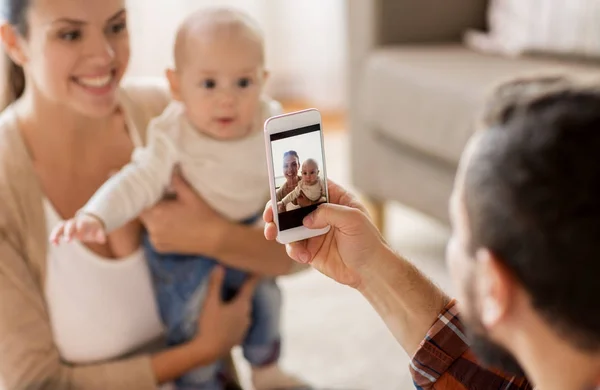 Happy family with baby photographing at home — Stock Photo, Image