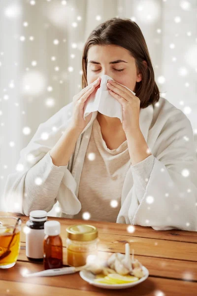 Sick woman with medicine blowing nose to wipe — Stock Photo, Image