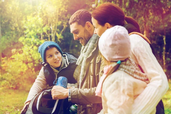 Happy family with backpacks and thermos at camp — Stock Photo, Image