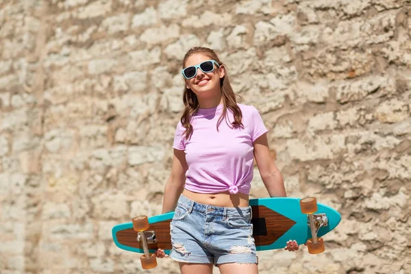 Happy teenage girl in shades with longboard — Stock Photo, Image