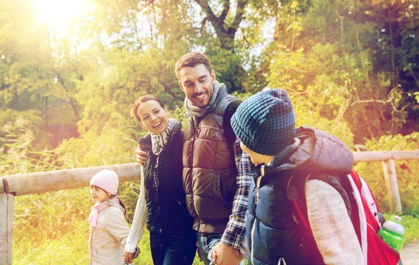 Happy family with backpacks hiking — Stock Photo, Image