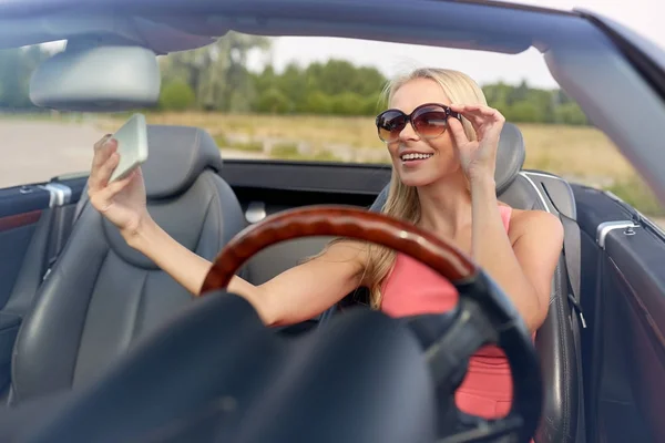 Mujer en coche descapotable tomando selfie — Foto de Stock