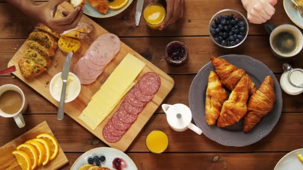 Group of people eating at table with food — Stock Video