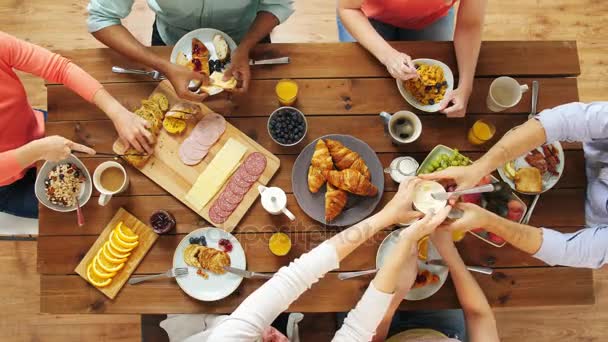 Group of people eating at table with food — Stock Video