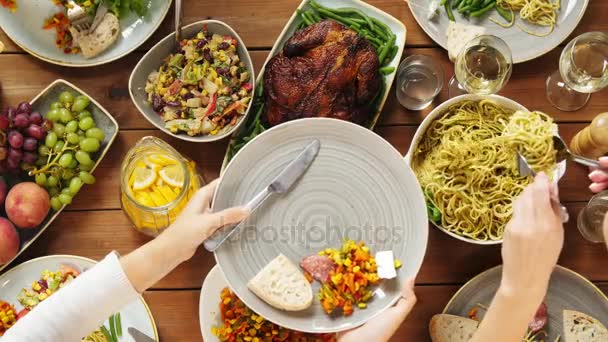 Personas comiendo pasta en la mesa con comida — Vídeo de stock