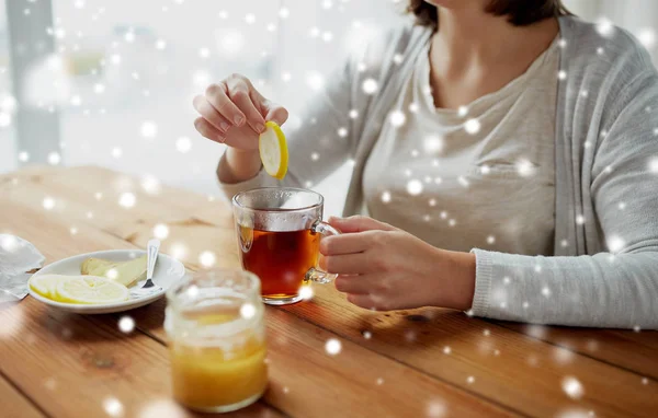 레몬 차에 꿀을 추가 하는 여자의 클로즈업 — 스톡 사진