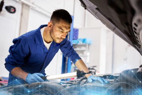 Mecánico hombre con lámpara de reparación de coches en el taller —  Fotos de Stock