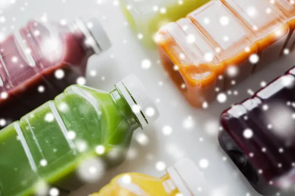 Bottles with different fruit or vegetable juices — Stock Photo, Image