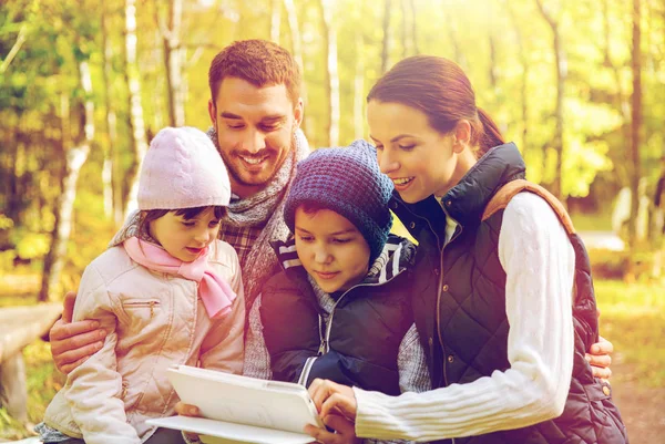 Happy family with tablet pc at camp — Stock Photo, Image