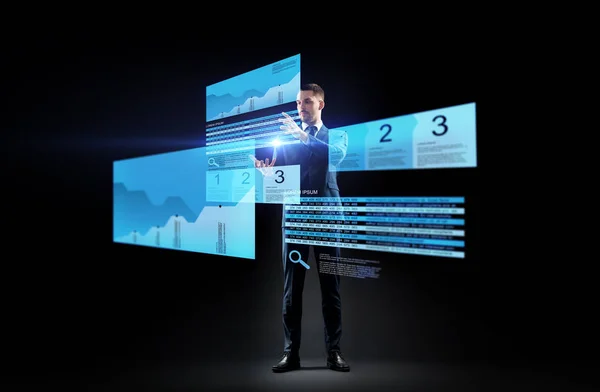 Бизнесмен с диаграммами акций на виртуальных экранах — стоковое фото