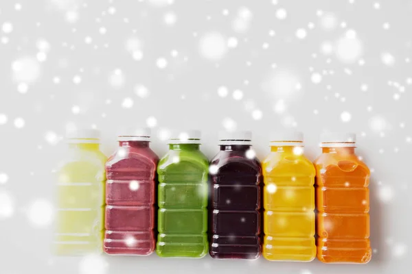 Bottles with different fruit or vegetable juices — Stock Photo, Image