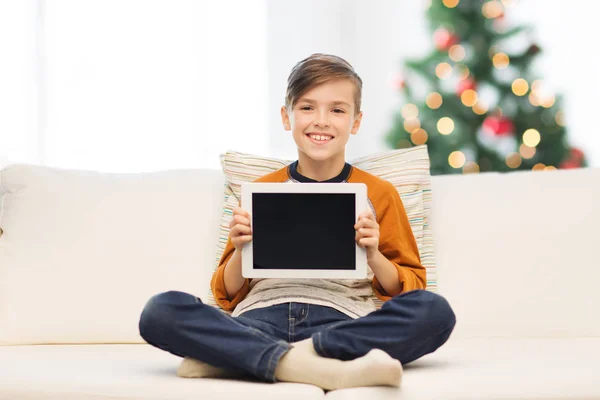 Smiling boy with tablet pc at home at christmas — Stock Photo, Image