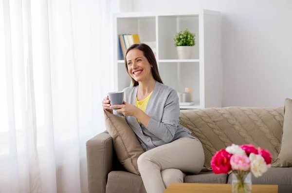 Mulher feliz bebendo chá ou café em casa — Fotografia de Stock