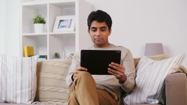 Indian man having video call on tablet pc at home — Stock Video