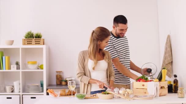 Feliz pareja cocina comida en casa cocina — Vídeo de stock