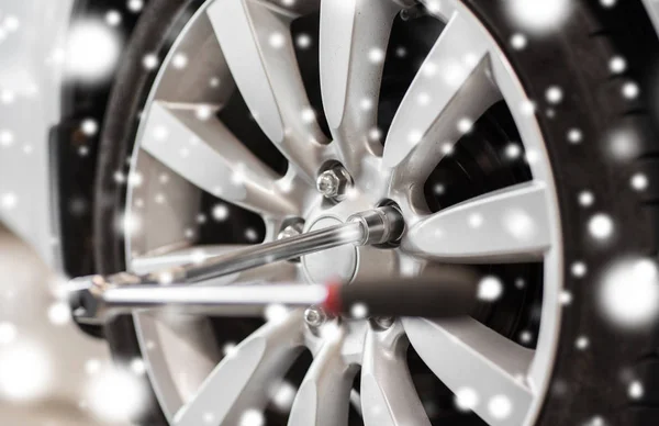 Screwdriver and car wheel tire — Stock Photo, Image