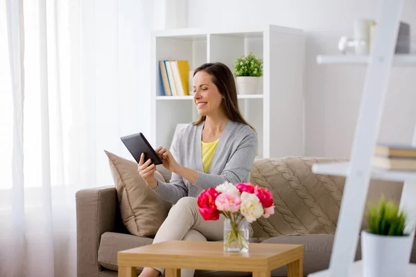 Femme heureuse avec tablette pc à la maison — Photo