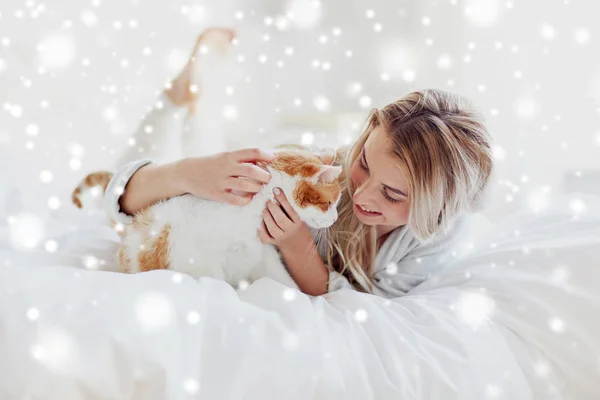 Jovem feliz com gato na cama em casa — Fotografia de Stock