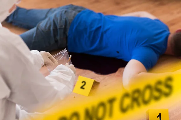 Criminalist collecting evidence at crime scene — Stock Photo, Image